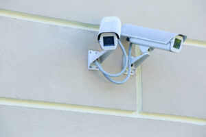 Zwei weiße Überwachungskameras an Hauswand